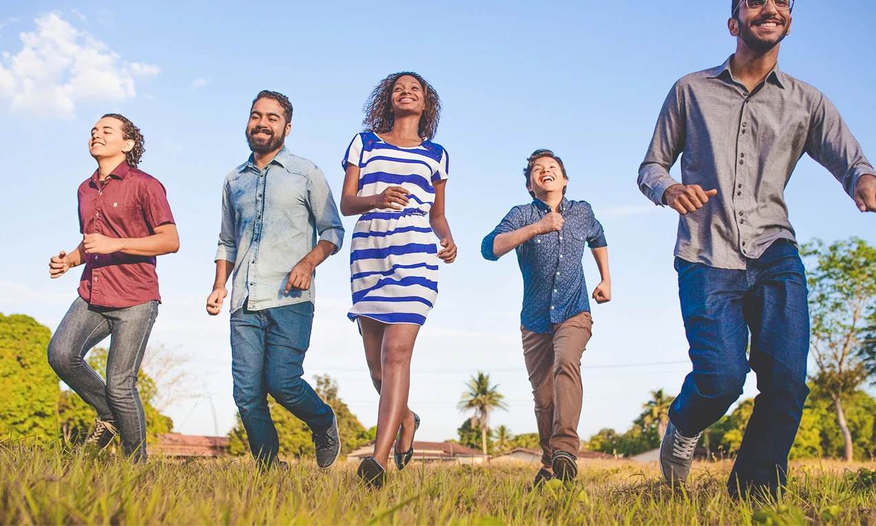 happy group of people walking towards the camera